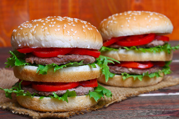 Closeup of home made burgers on wooden background