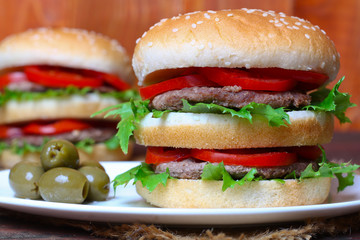 Closeup of home made burgers on wooden background