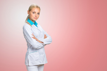 Beautiful smiling doctor woman in medical gown