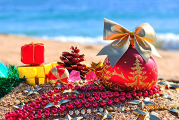 christmas bauble on sand on beach