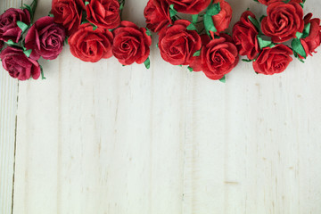 Bunch of red roses in light wood background