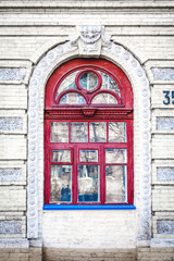 Fototapeta na wymiar wooden window in old brick building