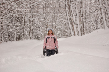 girl playing outdoors in snowy winter weather