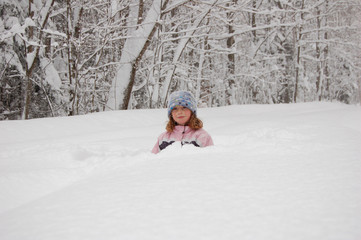 girl playing outdoors in snowy winter weather