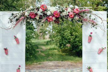 archway of many beautifil flowers, wedding arch with peones