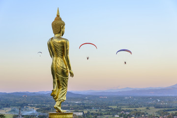 the standing Buddha statue with the para motor player before the sun set 
