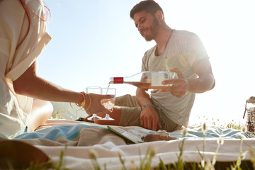 Young couple enjoying a picnic with wine