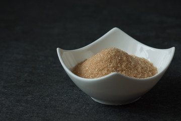 cane brown sugar in white bowl
