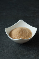 cane brown sugar in white bowl