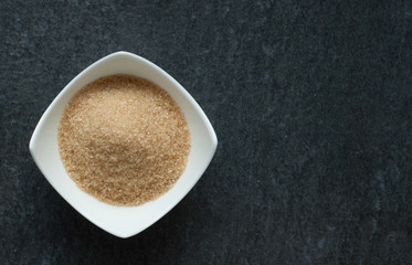 cane brown sugar in white bowl