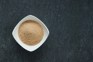 cane brown sugar in white bowl