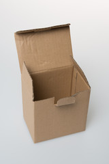 Recycled taped cardboard posting and shipping box with lid open isolated over white background.