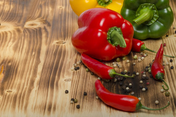 Chili and paprika on a wood plate
