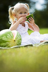 portrait of a little girl eating watermelon