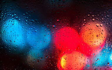 Night city lights through a wet window - 97221237