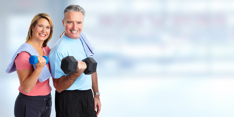 Senior couple with dumbbell.