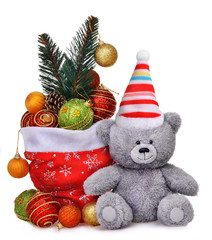 Christmas composition with santa claus bag full of toys and smiling teddy bear