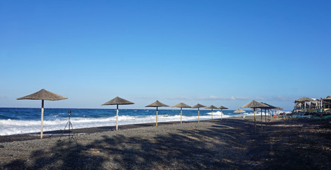 natural black lava beach koulombos on santorini island