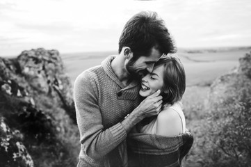 beautiful young couple on a background of rock cliff