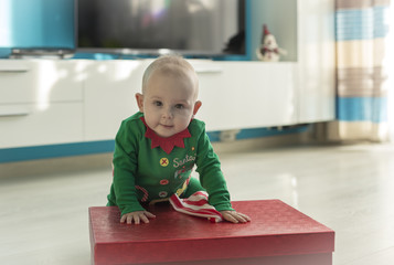 santa helper baby with red gift