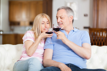 Portrait of a mature couple drinking a glass of red wine