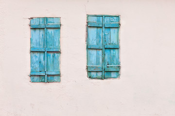 Blue painted wooden window and white wall