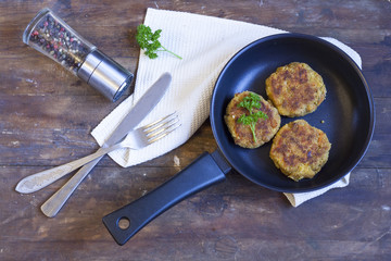 Burger (cutlet) In The Frying Pan. Burger (cutlet) in the frying pan on the wooden table