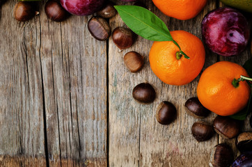 fruit. tangerines, plums, pumpkins, apples and chestnuts
