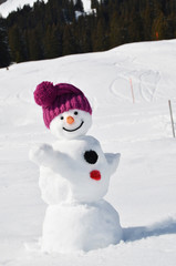 Naklejka premium Funny snowman against Swiss Alps