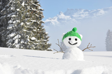 Obraz premium Snowman against Alpine scenery