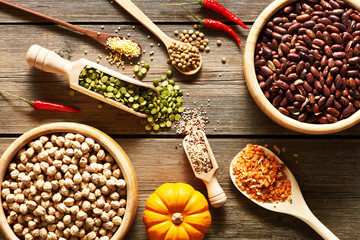 Bowls and spoons of various legumes