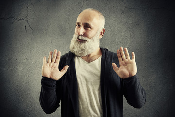 senior bearded man showing refusal sign