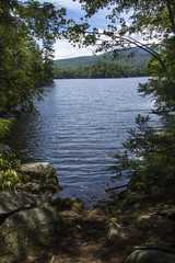 Fototapeta na wymiar Shoreline and fresh water of Mountain View Lake in Sunapee, New Hampshire.