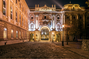 Entrance to the Royal Castle Square in Budapest at night. Buda Castle is home to the Hungarian National Gallery, the Budapest History Museum and the National Library