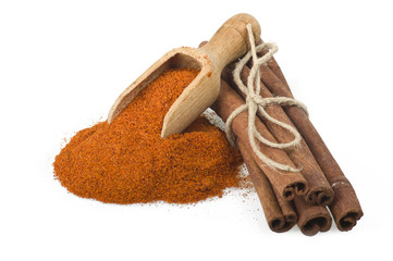 cinnamon sticks with powder on the white background
