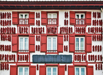 Red Espelette peppers drying in the wall of Basque house