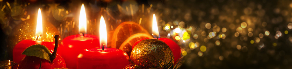 Four Advent candles with christmas decoration .