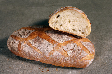 white bread lies on a grey linen tablecloth