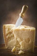 Küchenrückwand glas motiv Parmesan cheese cutting on the chopping board © Orlando Bellini