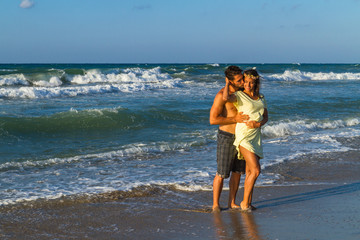 Attractive young couple in beachwear at the beach.