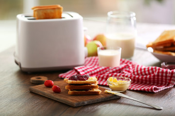 Served table for breakfast with toast, milk and jam, close-up