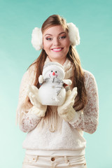 Smiling cute woman with little snowman. Winter.