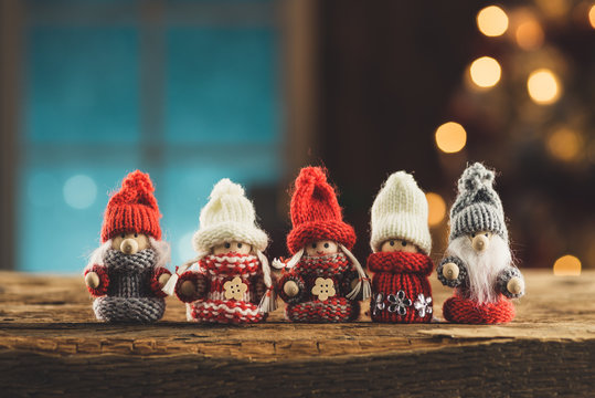 Gnomes family on wooden table in cosy cottage