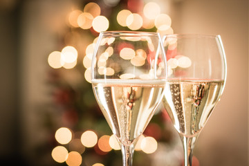 Glasses of sparkling white wine for Christmas and new year festivities - obrazy, fototapety, plakaty