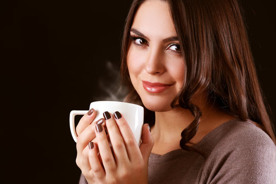 Portrait of smiling pretty woman with cup of coffee