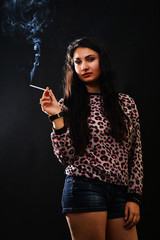 Woman Smoking a Cigarette on Black Background