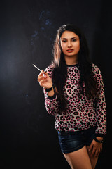 Woman Smoking a Cigarette on Black Background