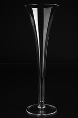 Empty champagne glass on black background