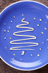 Christmas fir tree made from mayonnaise, on plate, close up