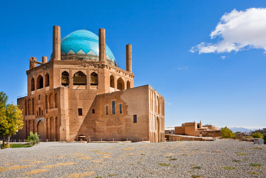 Blue domed ancient building of mausoleum Dome of Soltaniyeh under the clear sky with cloud. Iran.